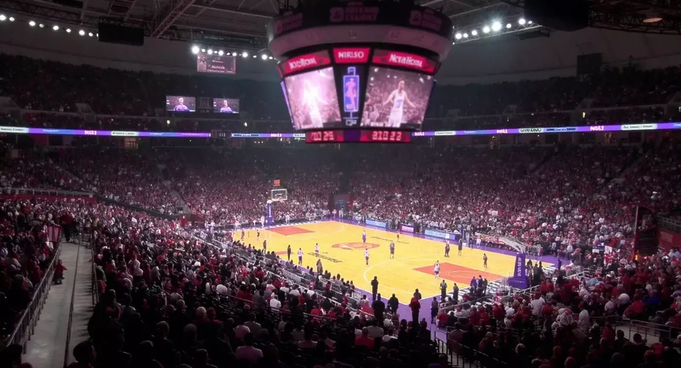 NBA basketball arena filled with fans during a professional game with the court illuminated under arena lights